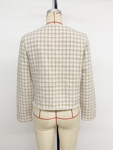 Detail view of tweed checkered jacket back with elegant pearl trim at the hemline