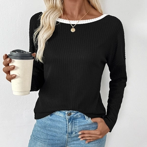 Women's black long sleeve knit top with white contrast neckline and ribbed texture