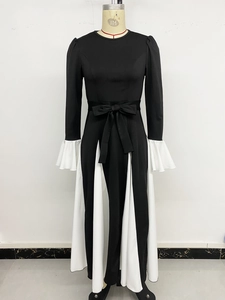 Detail of A-line dress featuring contrast patchwork hem and flared cuffs with bow waist