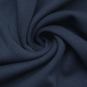 Macro detail of dark blue ribbed knit fabric showing high-quality textile texture