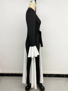 Detailed side view of A-line dress featuring white pleated patchwork and flare cuffs