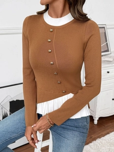 Detail of color-block knit sweater with gold buttons and white shirt-style trim