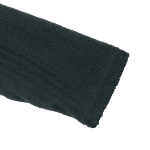 Detailed macro view of the dark green ribbed knit fabric texture and sleeve cuff finish