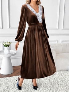 Detail of the elegant V-neckline with intricate white lace on brown velvet dress