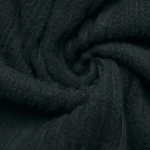 Detailed close-up of black knitted fabric texture with soft vertical ribbing and fuzzy wool finish