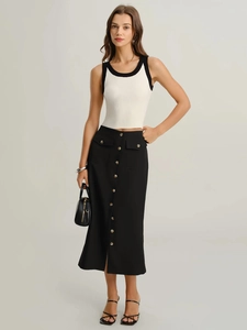 Detail of elegant black A-line midi skirt with button decor and flap pockets
