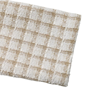 Macro shot of elegant beige checkered tweed fabric with detailed woven texture on jacket