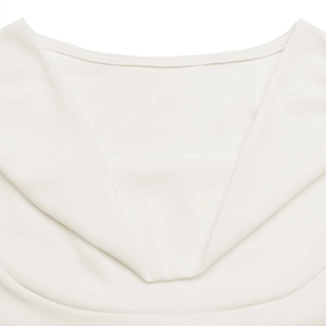 Close-up of the elegant draped neckline and fine ribbed knit texture of white top
