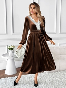Detail of V-neck lace trim and velvet texture on long sleeve winter evening dress