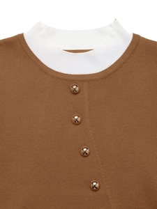 Detail of mock neck sweater featuring gold metal buttons and ribbed contrast collar