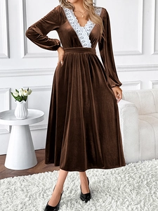 Detail of elegant V-neckline with delicate white lace trim on a brown velvet dress