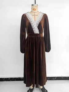 Detailed close-up of delicate white lace trim on a retro V-neck brown velvet maxi dress