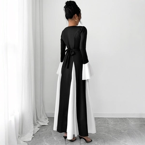 Elegant A-line long-sleeved dress with black-white contrast panels and flared cuffs
