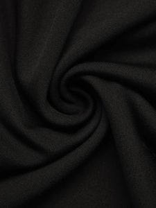 Macro shot of premium black knitted fabric showing fine texture and elegant drape