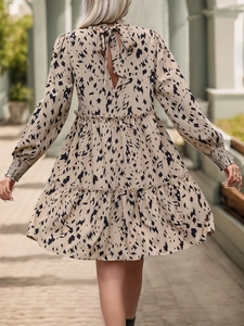 Detail view of the back tie-neck and tiered ruffle skirt with abstract leopard print
