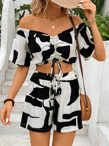 Women's summer two-piece set featuring off-shoulder crop top and high-waisted shorts with abstract print