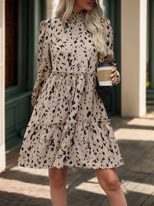 Detail of ruffle neck and leopard print pattern on women long sleeve tiered mini dress