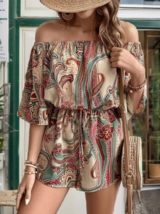 Detail view of ethnic paisley print jumpsuit with off-shoulder neckline and drawstring waist