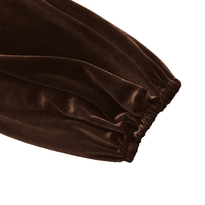 Detailed close-up of dark brown velvet dress sleeve with elastic cuff and soft texture