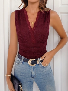 Detail of burgundy lace bodysuit with deep V-neck and eyelash trim on sleeveless top