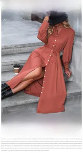 Detail showing tiered skirt hem and drawstring waist on a brick red long sleeve dress