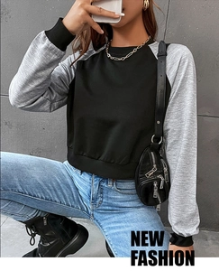 Details des Raglan-Sweatshirts mit schwarz-grauem Colorblock und gerippten Bündchen