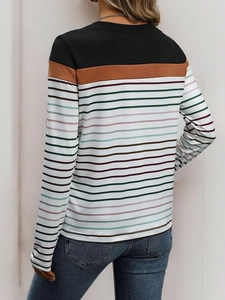 Rear view of long sleeve crewneck t-shirt with multi-color stripes and patchwork detail