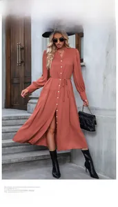 Detail of brick red long sleeve button-down dress with matching waist tie belt