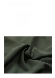 Detail view of deep green shirt dress fabric texture and material specifications info