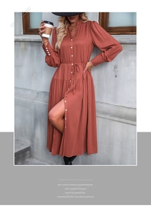 Detail of rust red long sleeve midi dress with waist tie and button-up design