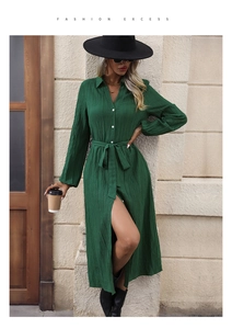 Close-up of green long sleeve dress featuring pleated texture and classic button-down lapel