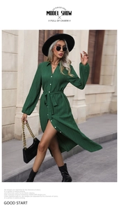 Detailed texture view of dark green pleated long sleeve shirt dress with buttons