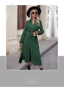 Detail of dark green pleated shirt dress with tie-waist and button-down front design
