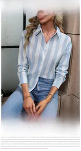Detail view of light blue striped long-sleeved shirt with classic collar and white buttons