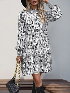 Detail of multi-tiered layered dress with leopard print and elegant long sleeves