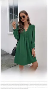 Detail of V-neck dark green long sleeve dress with ruched chest and ruffled cuffs