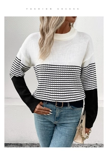 Detail of knit sweater showing black and white stripes and soft texture of the fabric