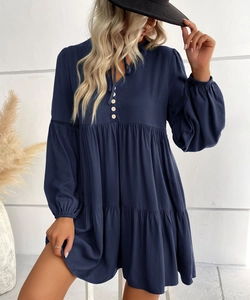 Detail of navy blue tiered mini dress with V-neckline and decorative front buttons
