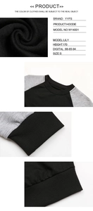 Detailansicht des schwarz-grauen Raglan-Sweatshirts mit Rippbündchen und Saumtextur