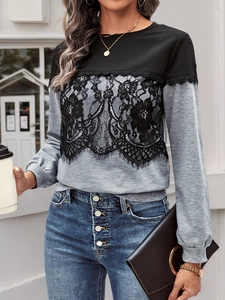 Close-up of color-block long sleeve top with black lace floral texture and ribbed cuffs