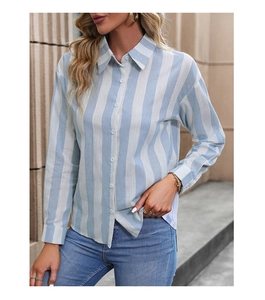Detail view of the classic vertical blue and white striped texture on long sleeve shirt