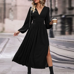 Detail of elegant black V-neck maxi dress featuring a side slit and waist pleats