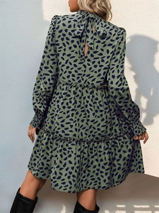 Detail of high neck back tie and cutout on this green leopard print long sleeve dress