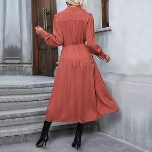 Elegant brick red long sleeve maxi dress with waist tie and pleated hem for autumn style