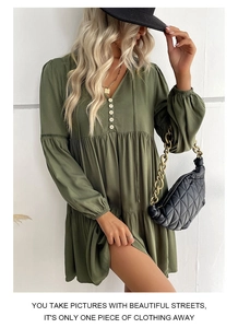 Detail view of army green mini dress featuring V-neck, buttons and ruffled layers