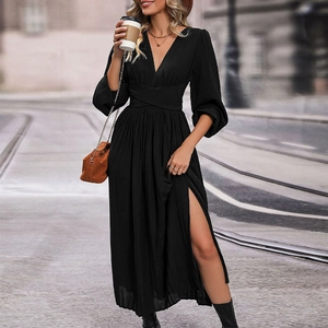 Detail of elegant black long sleeve dress with V-neckline and high side slit detail