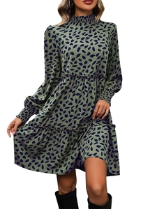 Detail view of the smocked high neck and elastic cuffs on this green leopard print dress