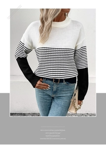 Detail of color-block knit sweater featuring black and white stripes and round neck