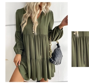 Close-up of army green babydoll dress showing layered ruffle hem and button details