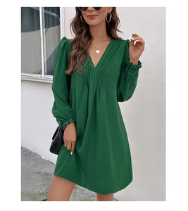 Detail of dark green V-neck dress with pleated chest design and ruffled long sleeves